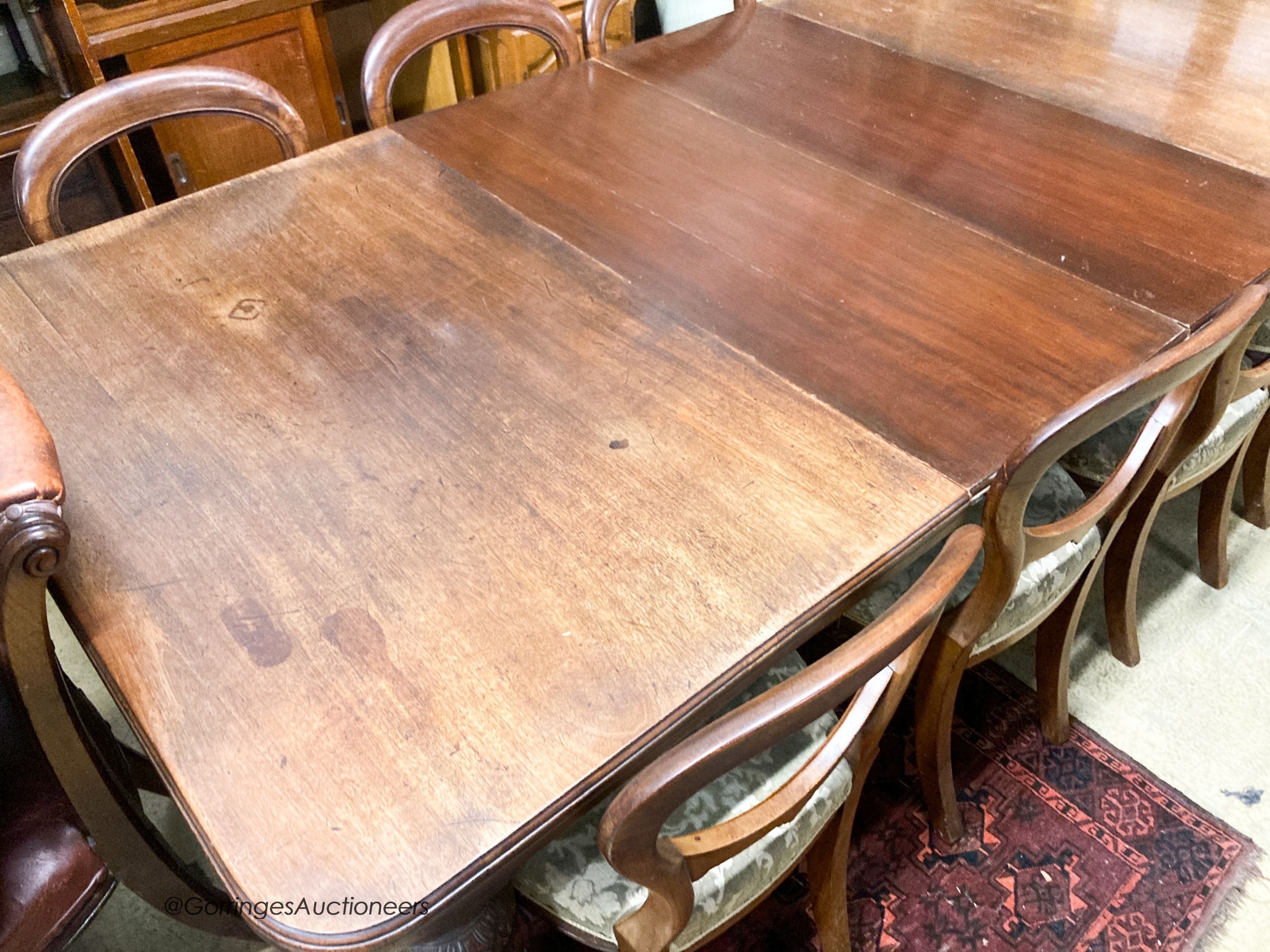 A late Victorian mahogany extending dining table, 238cm extended, two spare leaves, depth 118cm, height 72cm together with a set of eight Victorian mahogany balloon back dining chairs